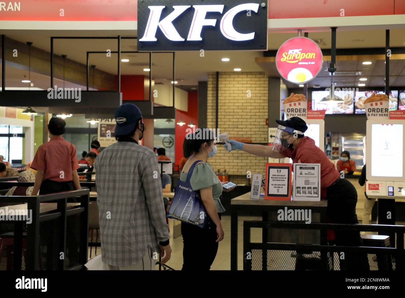 A Worker Checks A Customer S Body Temperature Before Entering A Kfc Restaurant Amid The Coronavirus Disease Covid 19 Outbreak In Petaling Jaya Malaysia May 29 2020 Reuters Lim Huey Teng Stock Photo Alamy