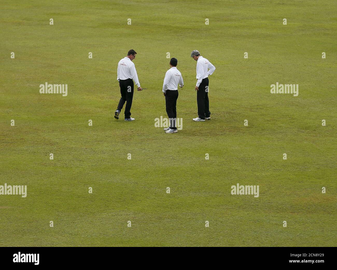 Umpires Nigel Llong (R) , Rod Tucker (L) and Ruchira Palliyaguruge inspect the ground condition after the rain, on the first day of third and final test cricket match between India and Sri Lanka in Colombo , August 28, 2015. REUTERS/Dinuka Liyanawatte Stock Photo