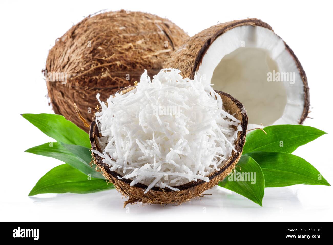 Coconut fruit and shredded coconut flakes in the piece of shell