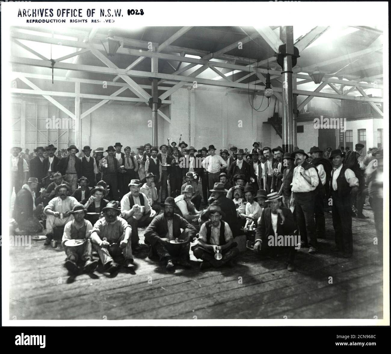 Interior of warehouse showing workers at lunch _ Stock Photo