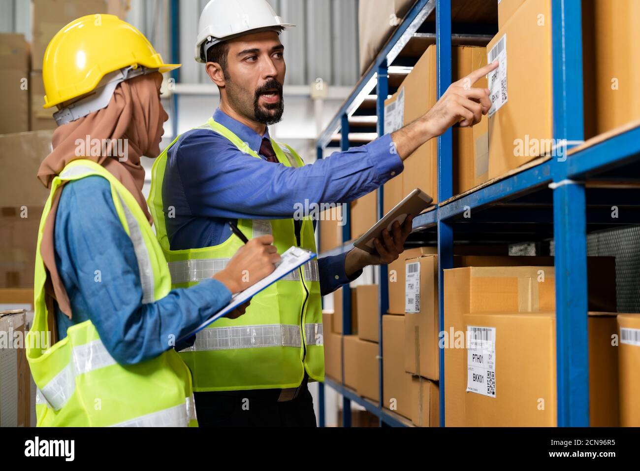 Warehouse manager talk with worker about logistic Stock Photo