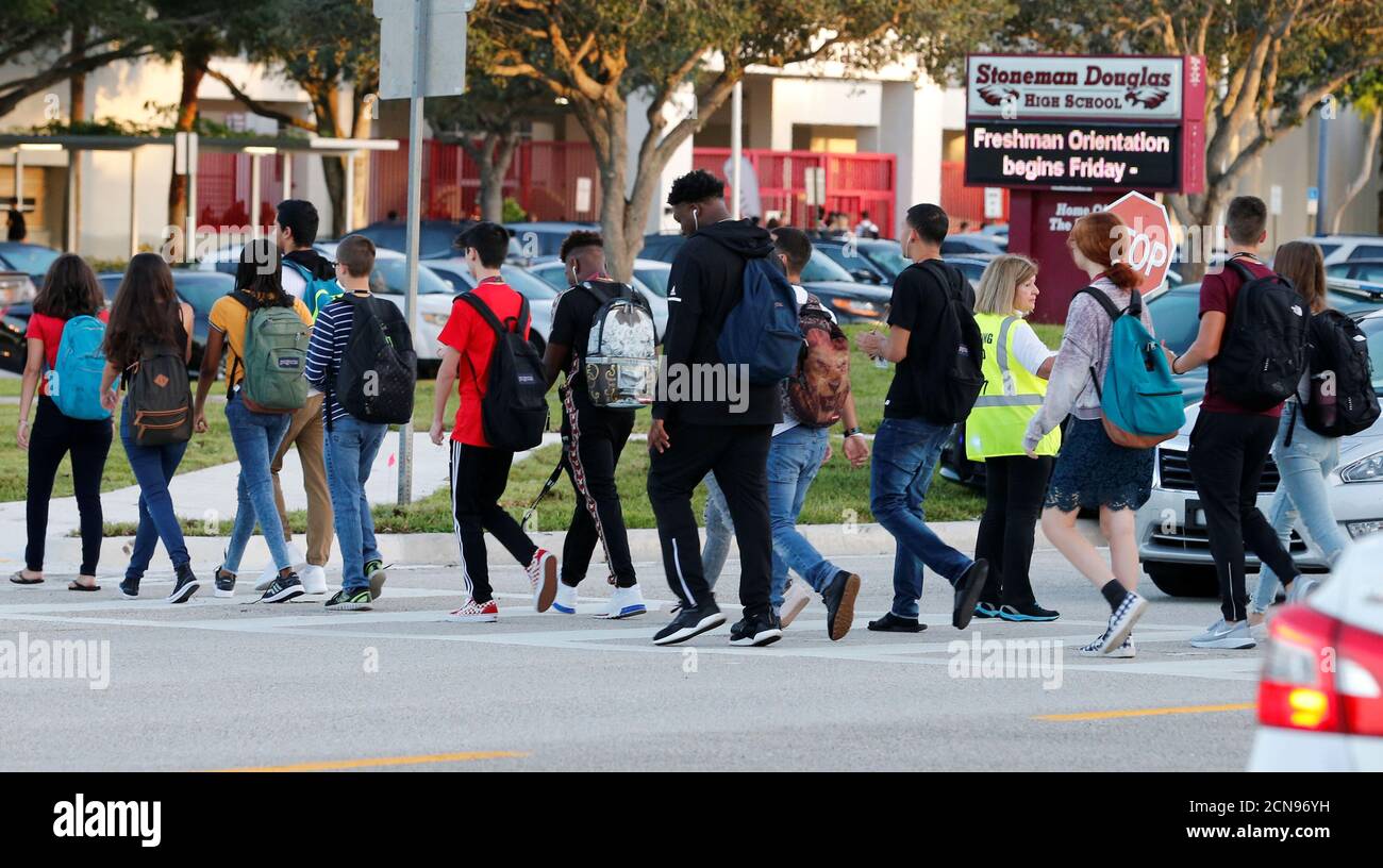 Students cross a street to enter for the first day of classes at Marjory Stoneman Douglas High School in Parkland, Florida, U.S. August 15, 2018.  REUTERS/Joe Skipper Stock Photo