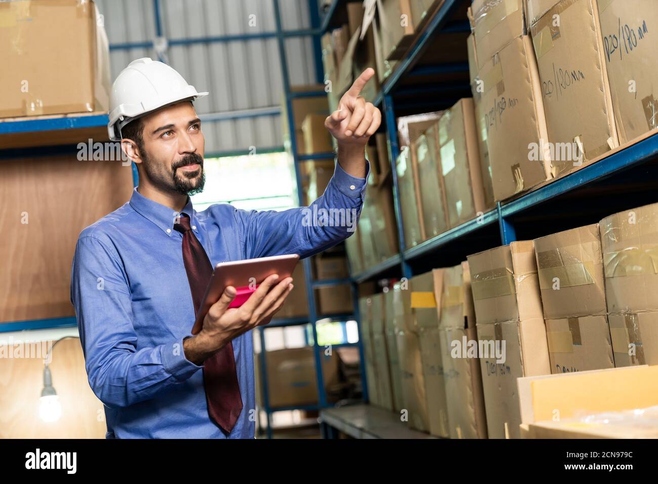 Middle east warehouse manager using tablet do inventory Stock Photo