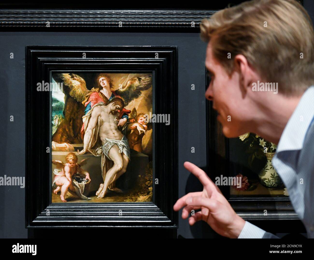 A man looks at the masterpiece 'The Body of Christ Supported by Angels' by the Flemish painter Bartholomeus Spranger at Rijksmuseum, which reopened after the ease of the lockdown measures during the coronavirus disease (COVID-19) outbreak, in Amsterdam, Netherlands June 1, 2020. REUTERS/Piroschka van de Wouw Stock Photo