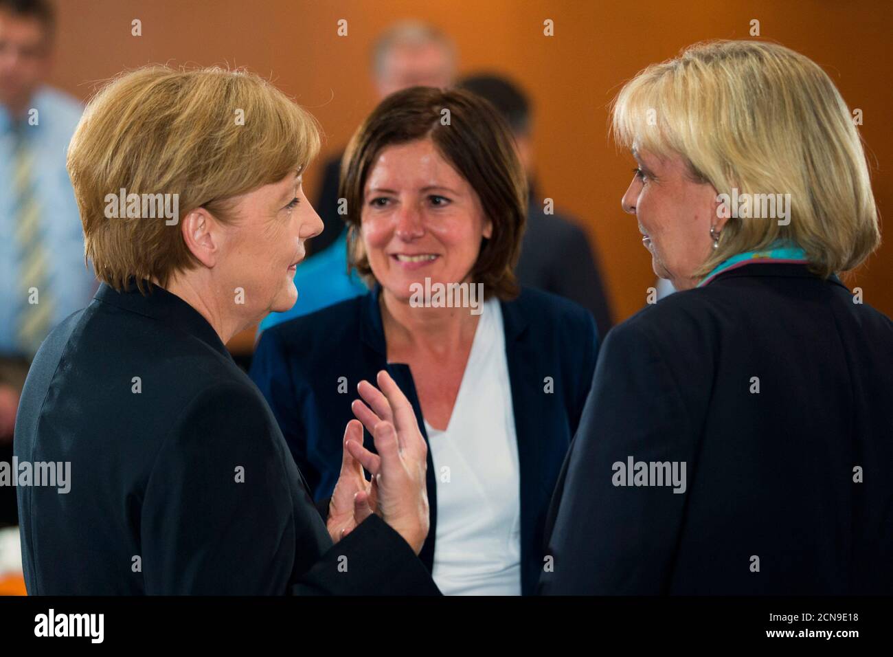 German Chancellor Angela Merkel (L) talks with Rhineland-Palatinate State Prime Minister Malu Dreyer (2nd L) and North Rhine-Westphalia State Premier Hannelore Kraft before a meeting of the government with the heads of Germany's federal states at the Chancellery in Berlin, June 12, 2014. REUTERS/Thomas Peter (GERMANY - Tags: POLITICS) Stock Photo