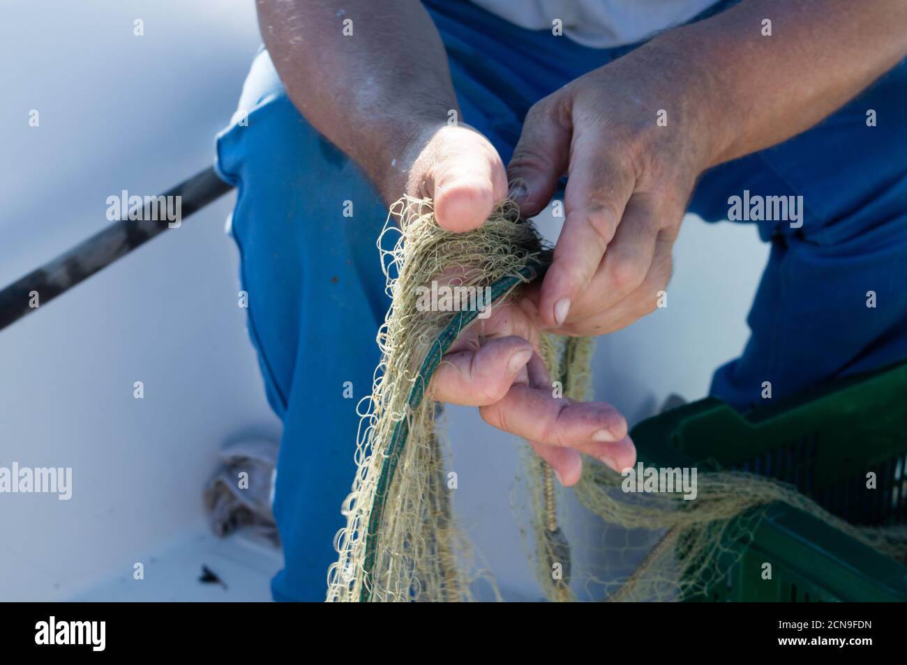 Fisherman holding an old fishing net, small traditional Croatian fishing  from Dalmatia, Croatia Stock Photo - Alamy