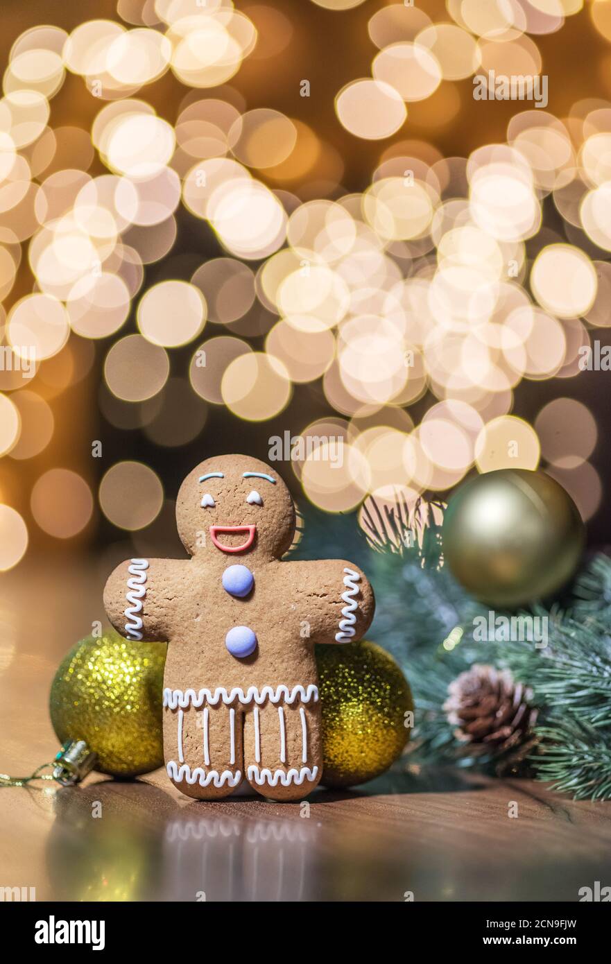 Gingerbread man on a Christmas background. Background with cookie and New Year decorations. Stock Photo
