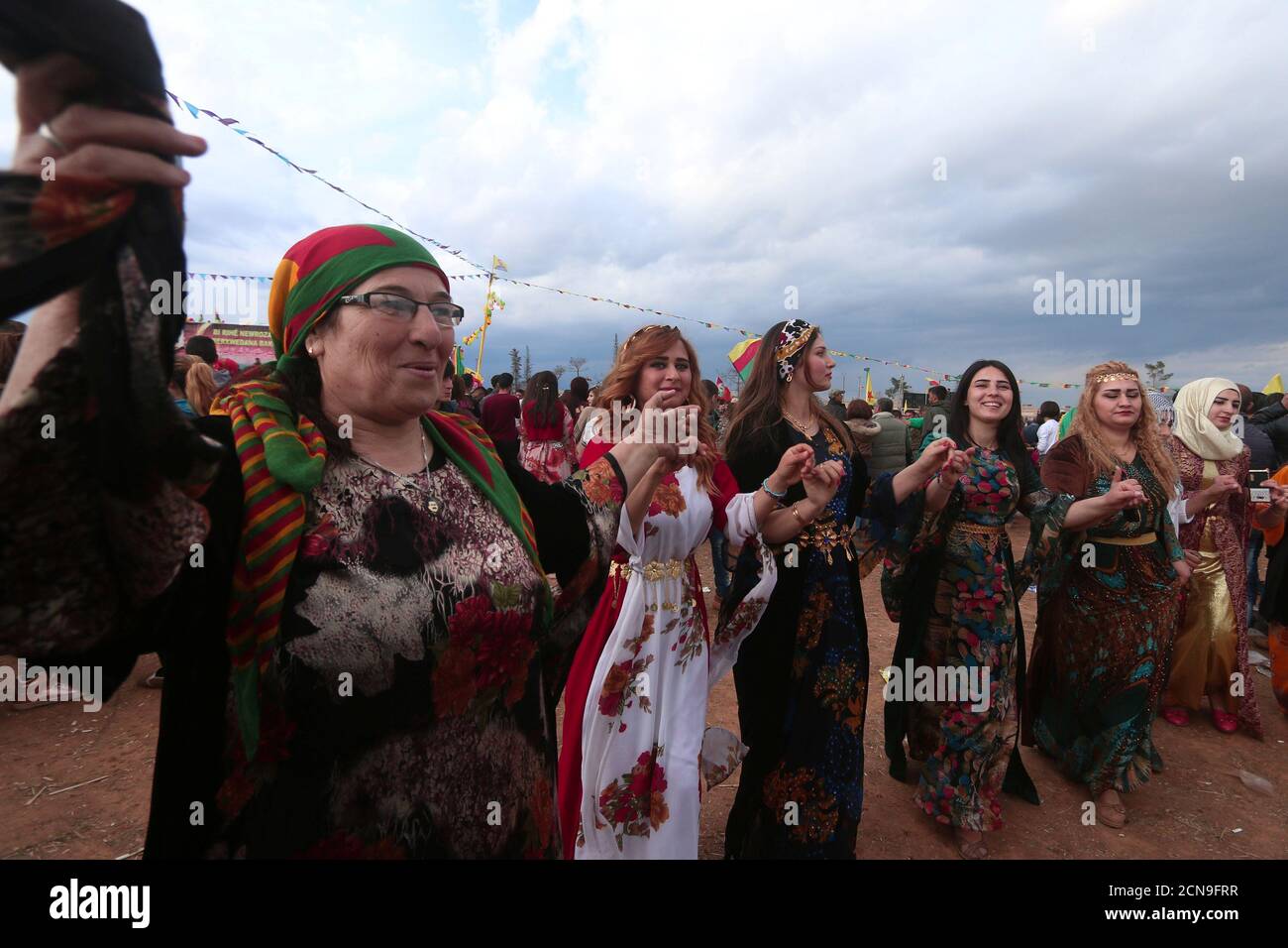 Kurdish women wearing traditional clothes dance during a celebration for  the spring festival of Nowruz, in the northeastern Syrian city of Qamishli  near the Turkish border, Syria March 21, 2017. REUTERS/Rodi Said