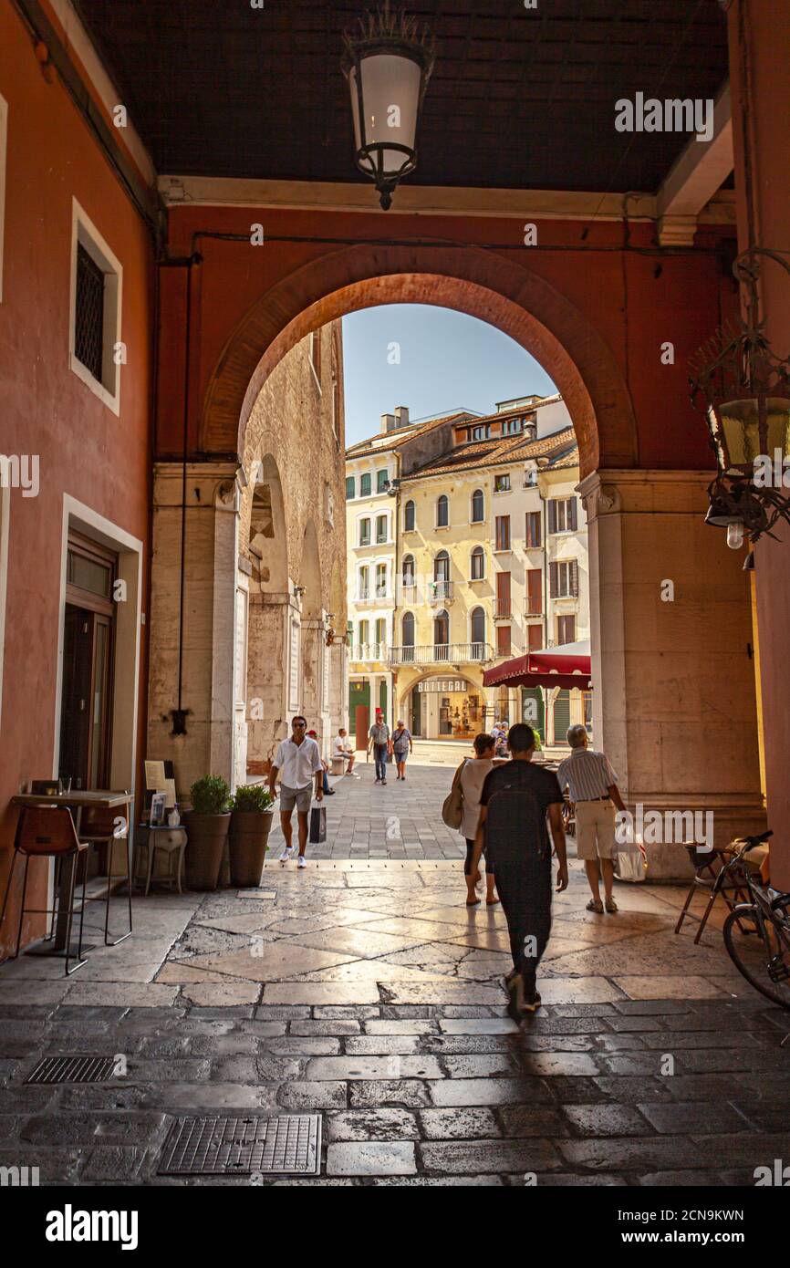 Arcades in Piazza dei signori in Treviso with people passing through Stock Photo