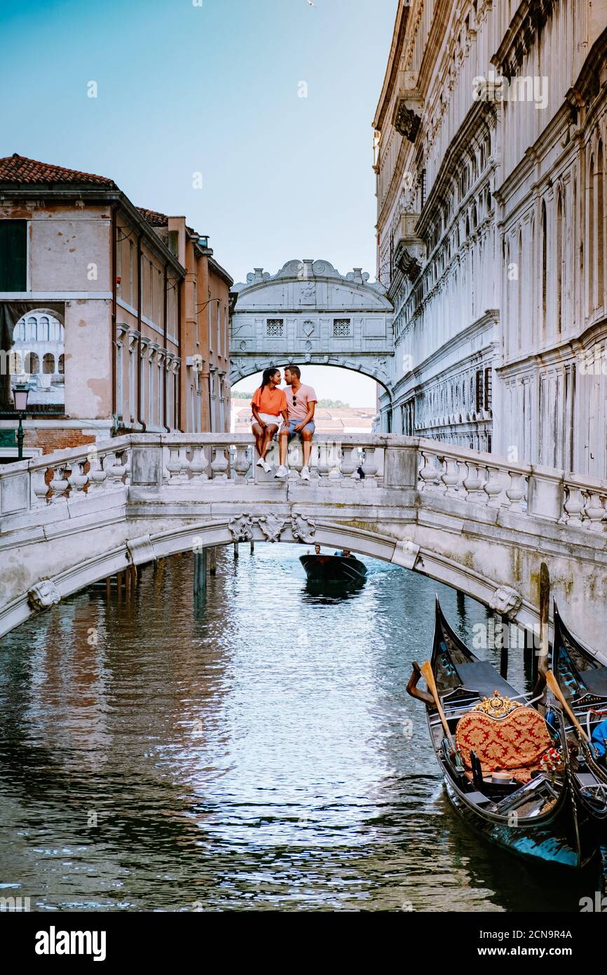 couple men and woman on a city trip to Venice Italy, colorful streets with canals Venice Stock Photo