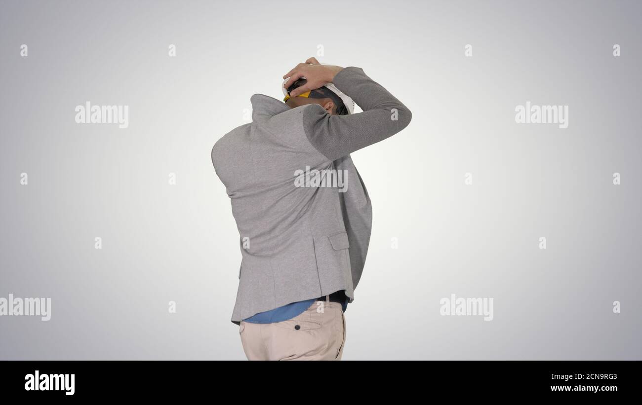 Arabian engineer with hardhat walking Safety concept on gradient Stock Photo