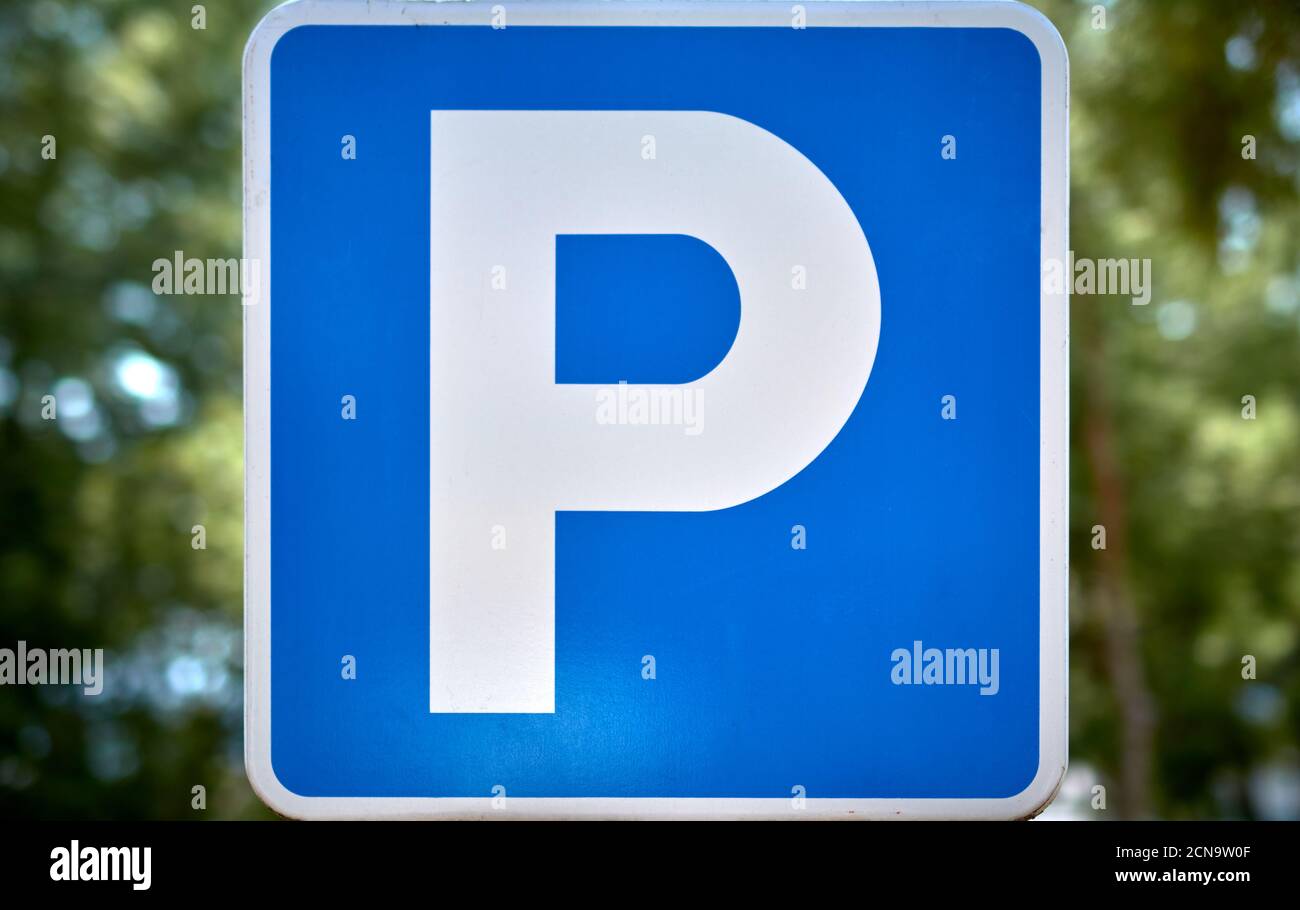 detail of a parking sign in a street with trees Stock Photo