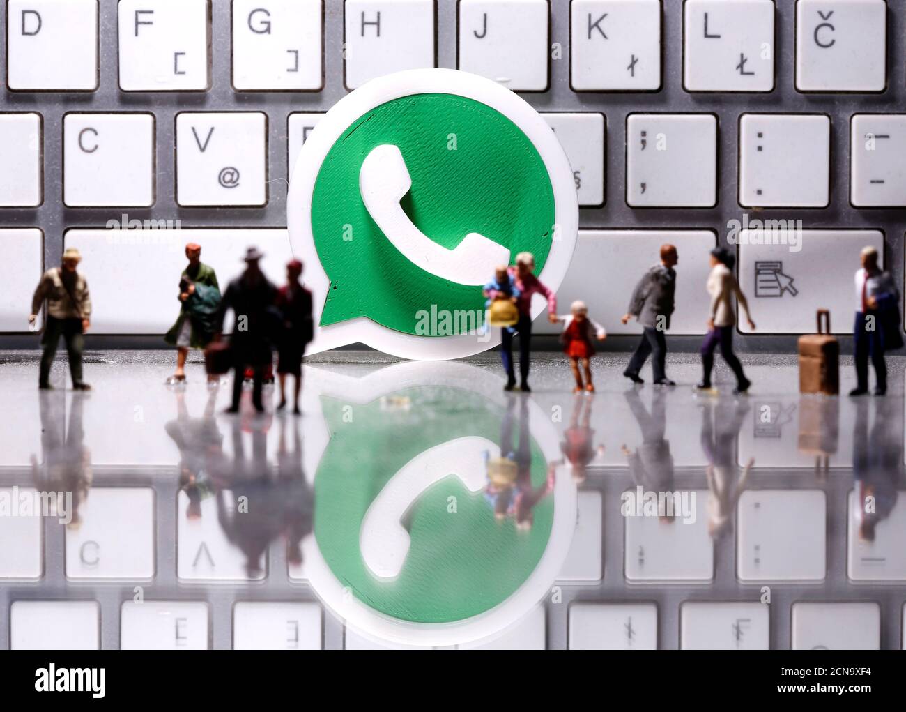 A 3D printed Whatsapp logo is placed between small toy people figures in  front of a keyboard in this illustration taken April 12, 2020. REUTERS/Dado  Ruvic/Illustration Stock Photo - Alamy
