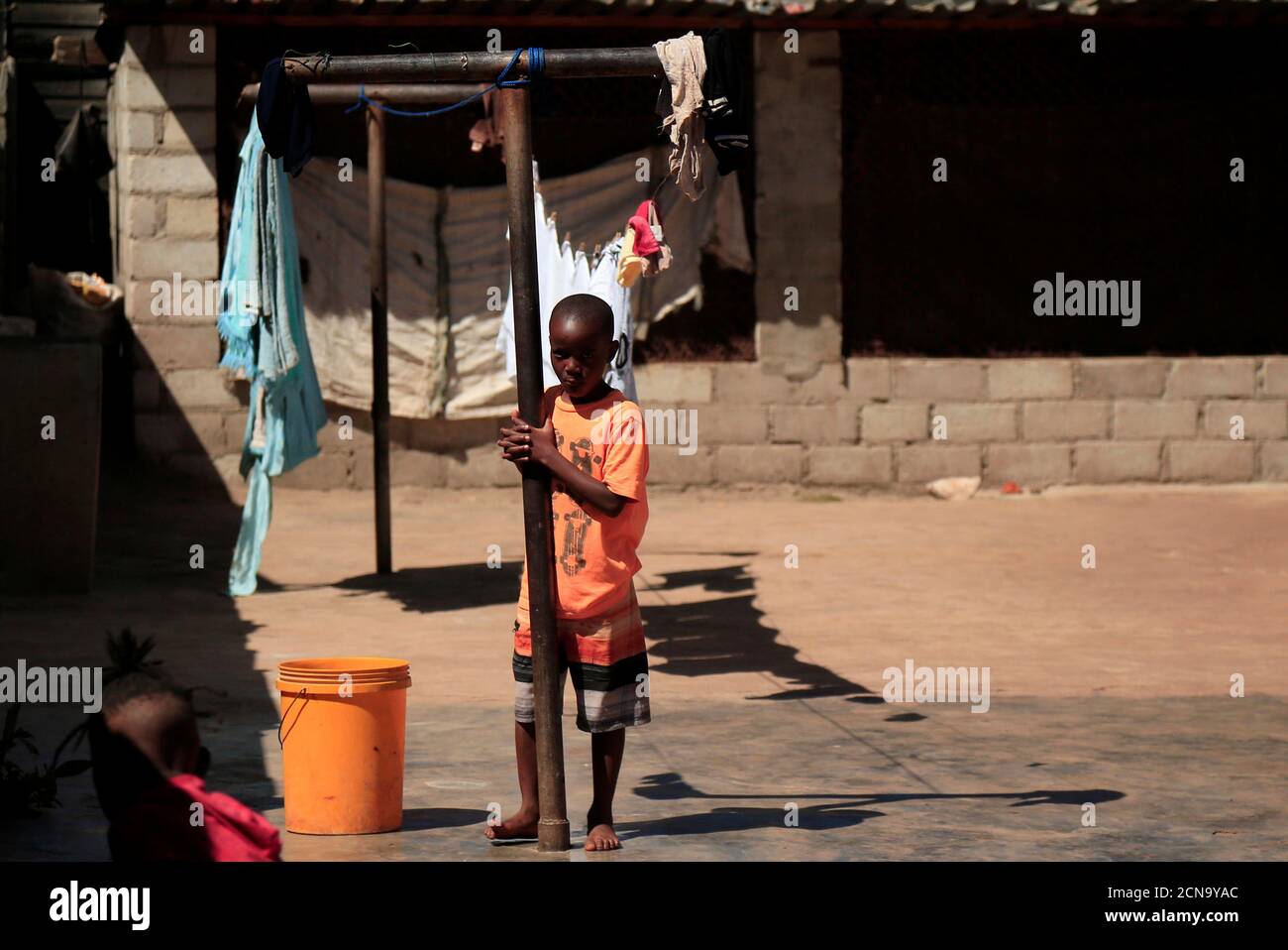 Densel Pamire plays outside his family's home during a nationwide lockdown to help curb the coronavirus disease (COVID-19) spread in Harare, Zimbabwe, May 9, 2020. Picture taken May 9, 2020. REUTERS/Philimon Bulawayo Stock Photo