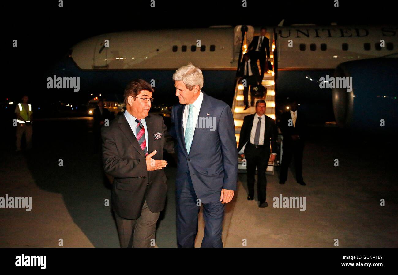 U.S. Secretary of State John Kerry talks with Afghanistan's Ministry of Foreign Affairs chief of protocol Ambassador Hamid Siddiq (L) as Kerry arrives at Kabul International airport in Kabul, July 11, 2014. Kerry is expected to meet with Afghanistan's President Kharzai as well as both candidates in Afghanistan's recent presidential election.  REUTERS/Jim Bourg    (AFGHANISTAN - Tags: POLITICS) Stock Photo