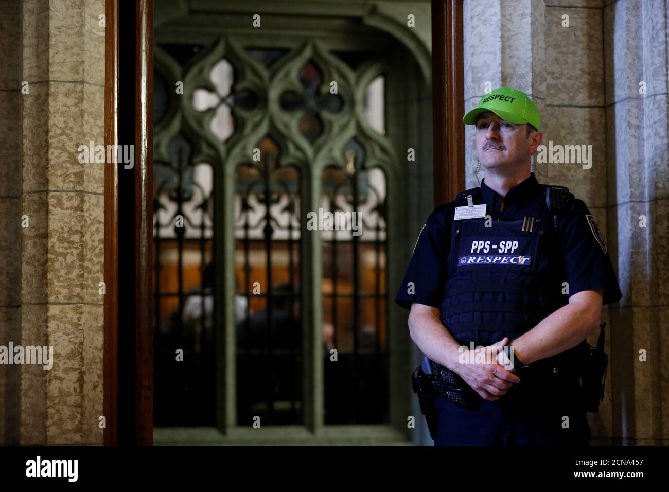 A Parliamentary Protective Service (PPS) officer wears a ball cap and a sticker with the word 'Respect' as part of an ongoing labour dispute, on Parliament Hill in Ottawa, Ontario, Canada May 18, 2017. REUTERS/Chris Wattie Stock Photo