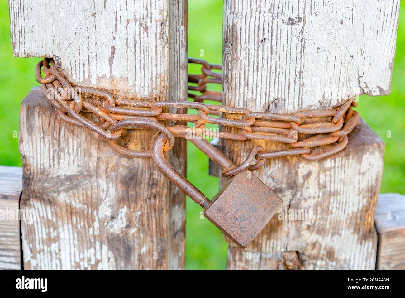 Rusty iron lock on the old gate Stock Photo