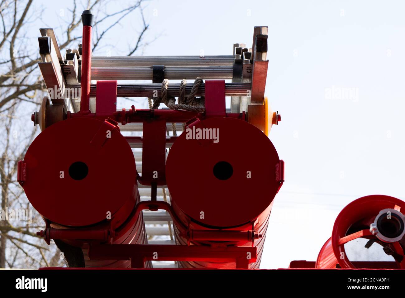 a fire truck, rear view of canisters for transporting suction hoses