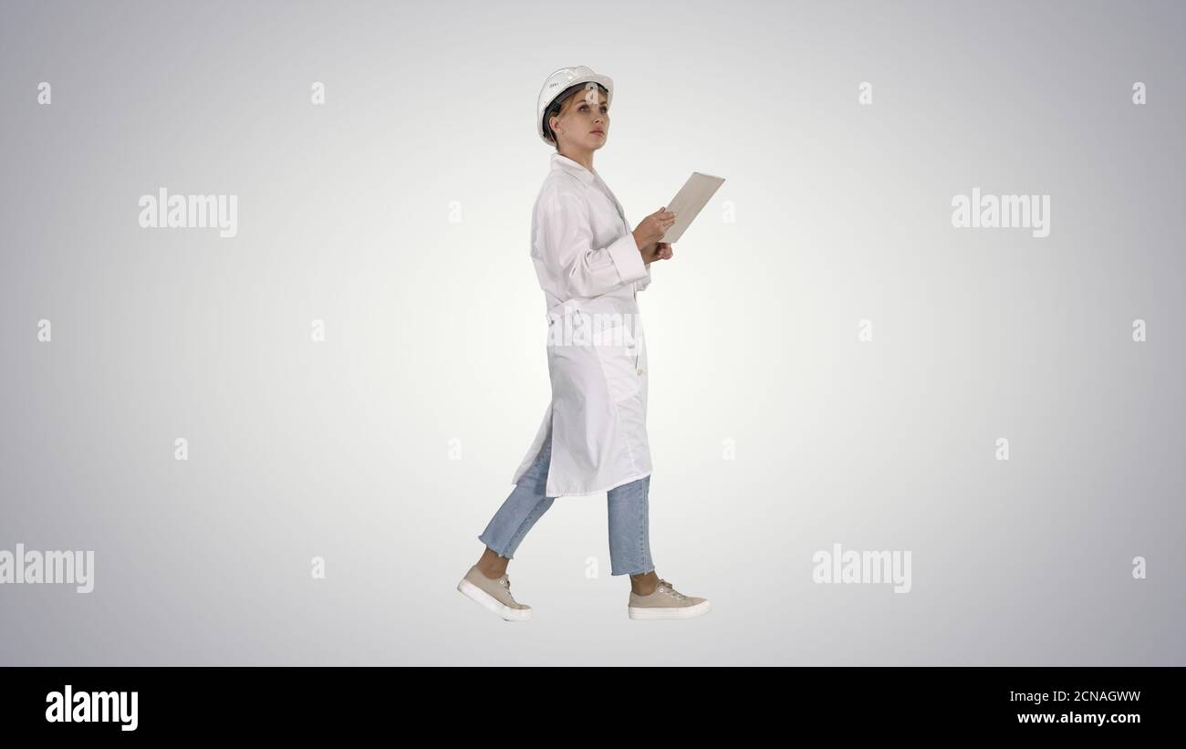 Young technician inspecting and taking necessary notes on digita Stock Photo