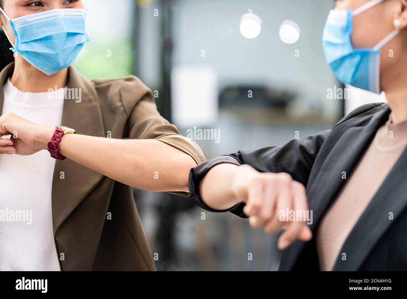 businesswomen wear face mask elbow greeting in new normal office lifestyle Stock Photo