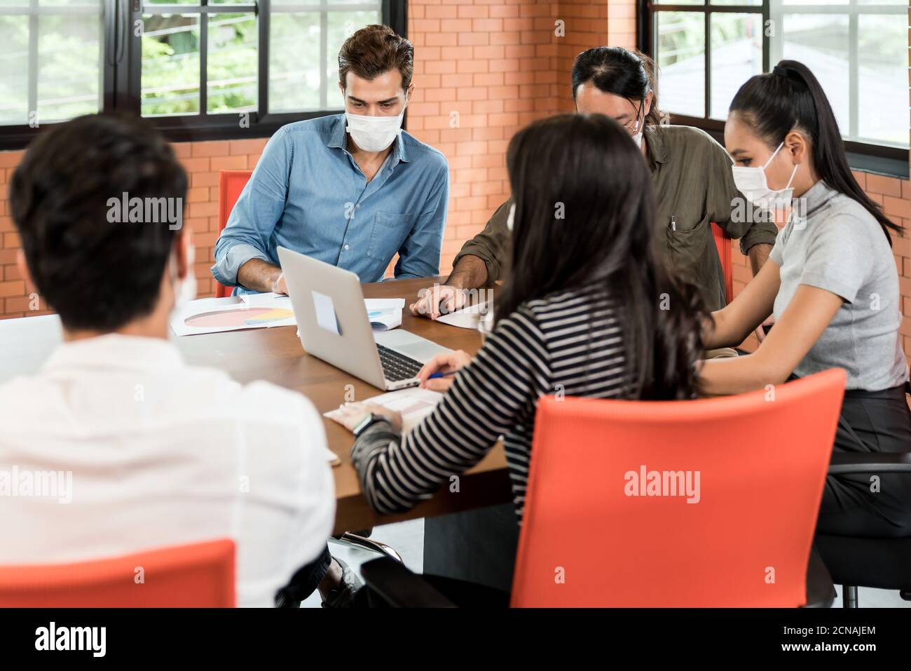 Business person brainstorm in meeting room with face mask Stock Photo ...
