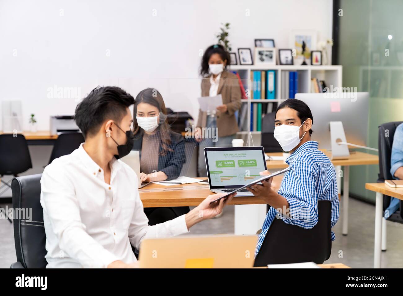 Social distance office with business team wear face mask as new normal ...