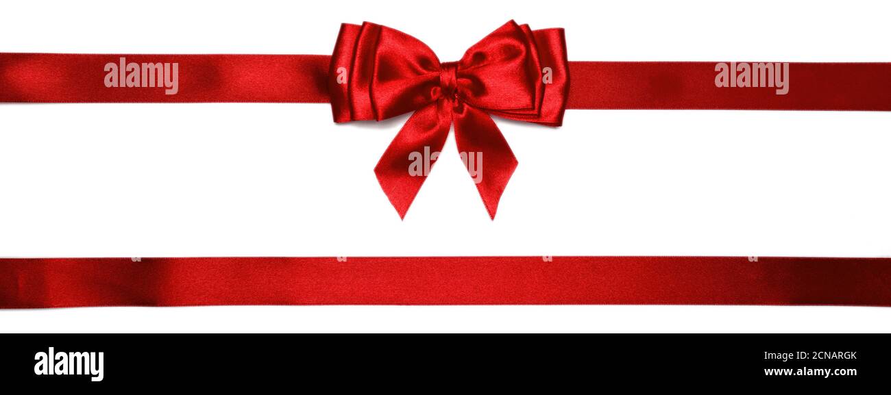 Red shiny bow with ribbons with long ribbon extending on both sides. Stock Photo
