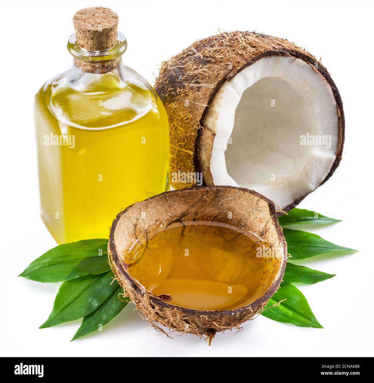 Cracked coconut fruit and coconut oil isolated on white background. Stock Photo