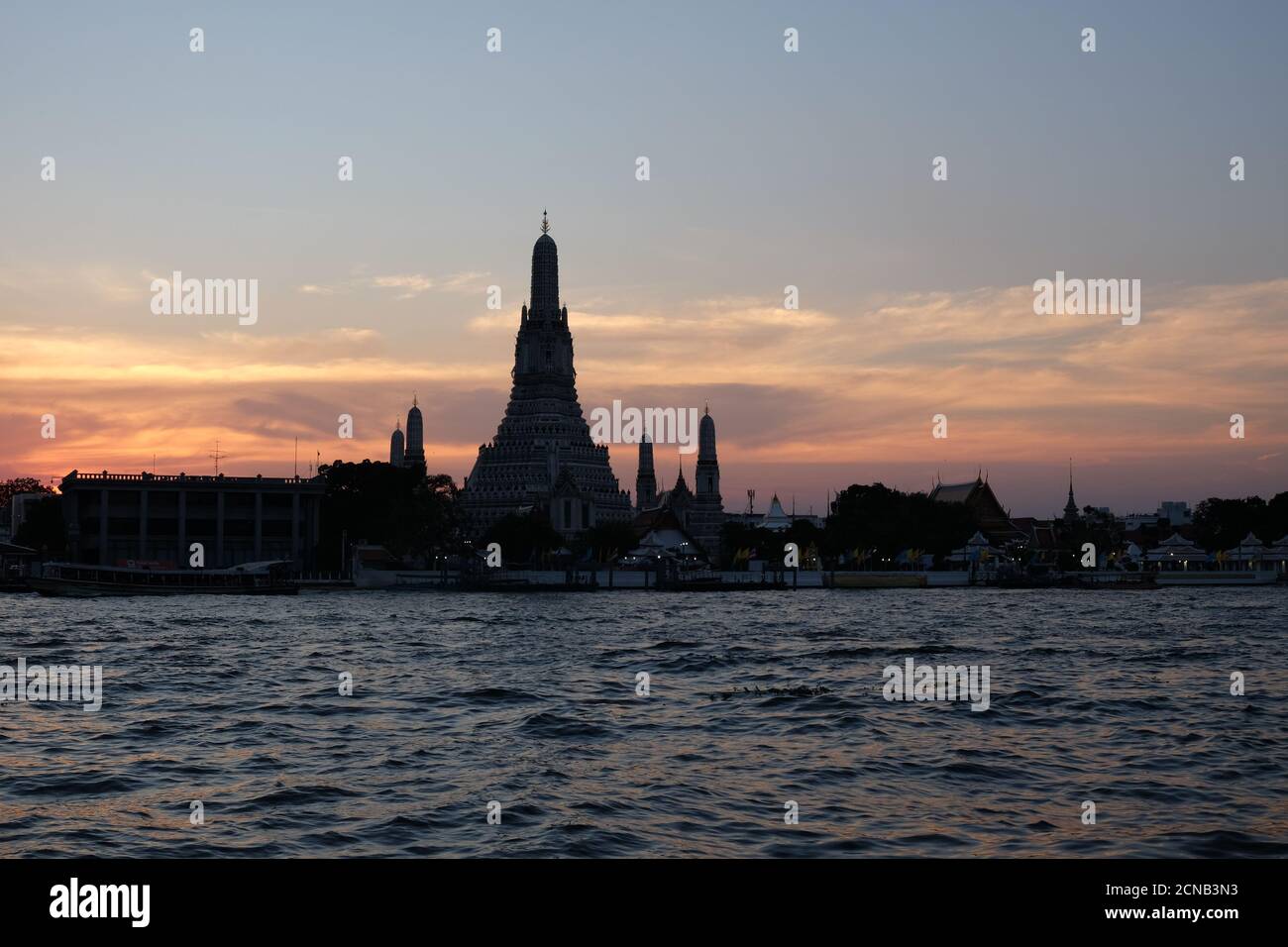 Bangkok, Thailand, December 25, 2018. Wat Arun Temple stands on the banks of the Chao Phraya River at dusk. Stock Photo