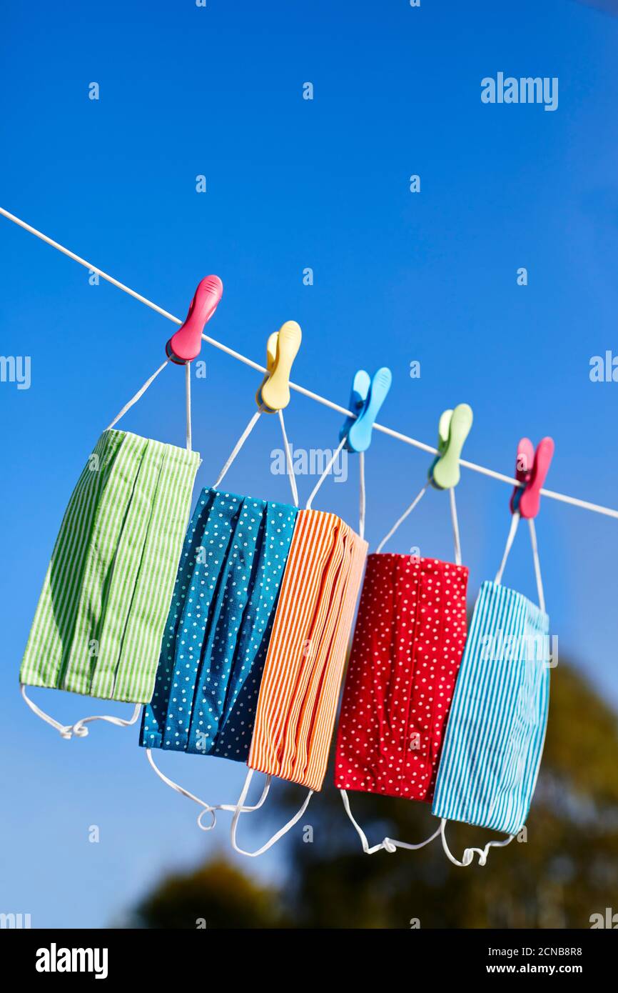 colourful face masks hanging on a washing line Stock Photo