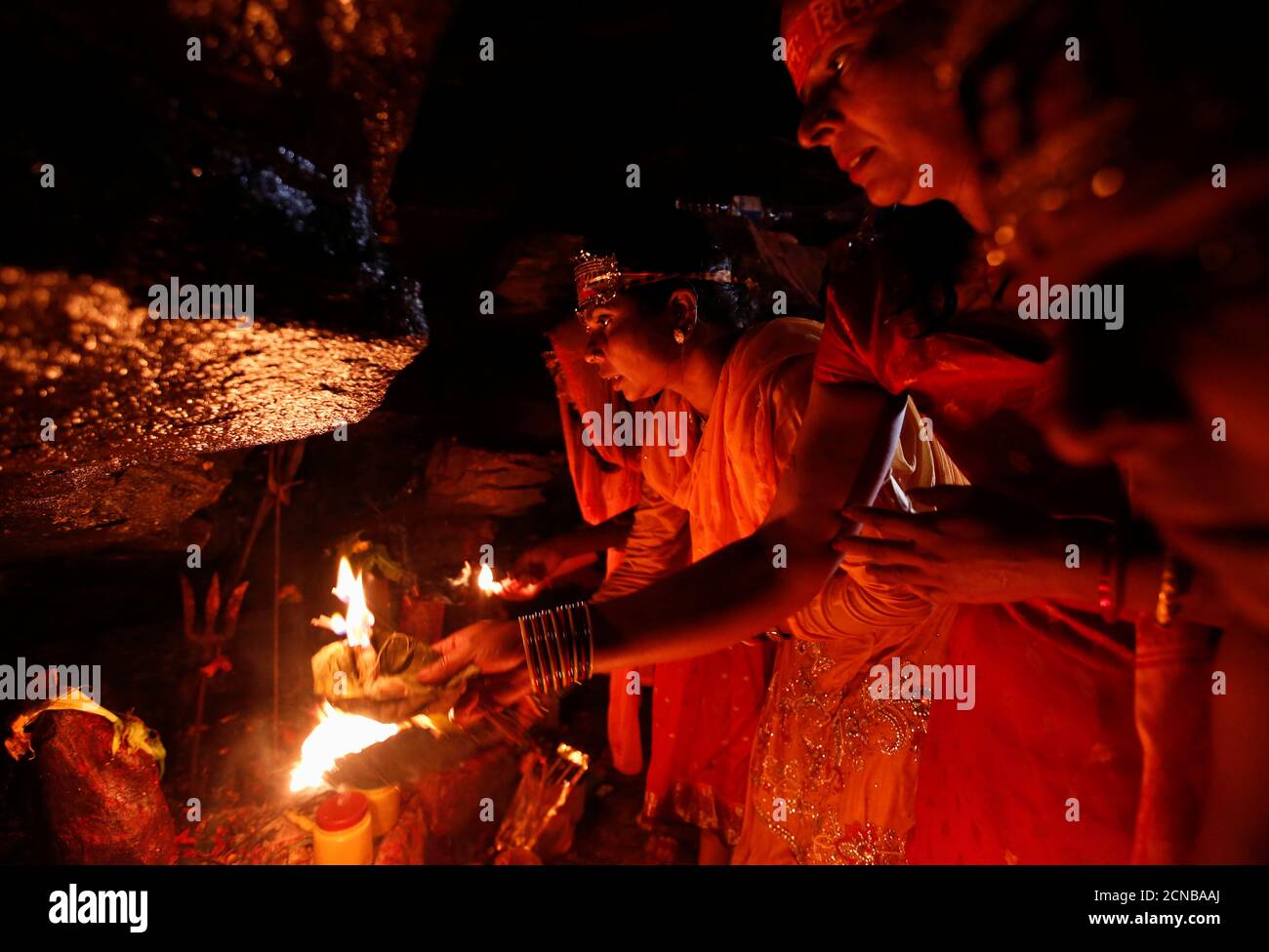 Devotees perform religious rituals as they take part in the "Bol Bom" (Say  Shiva) pilgrimage in Kathmandu, Nepal, July 30, 2018. The faithful,  chanting the name of Lord Shiva, trek about 15