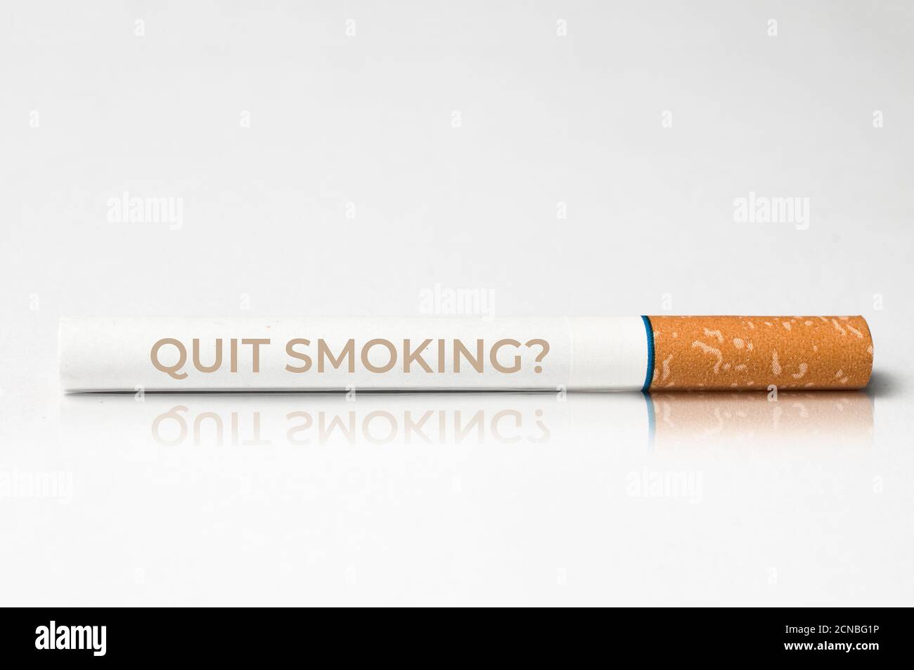 Quit smoking concept: close up of a cigarette with the message quit smoking printed on it Stock Photo