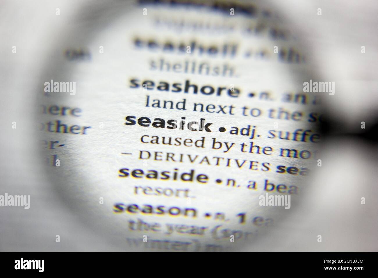 The word or phrase Seasick in a dictionary Stock Photo