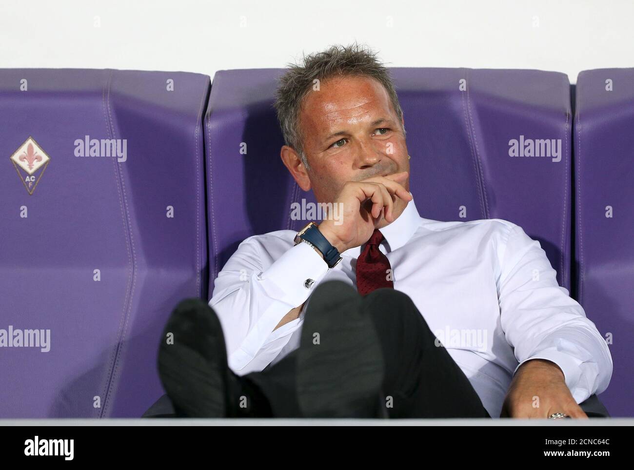 AC Milan coach Sinisa Mihajlovic sits before the start of their Italian Serie A soccer match against Fiorentina in Florence, Italy, August 23, 2015.   REUTERS/Alessandro Bianchi Stock Photo
