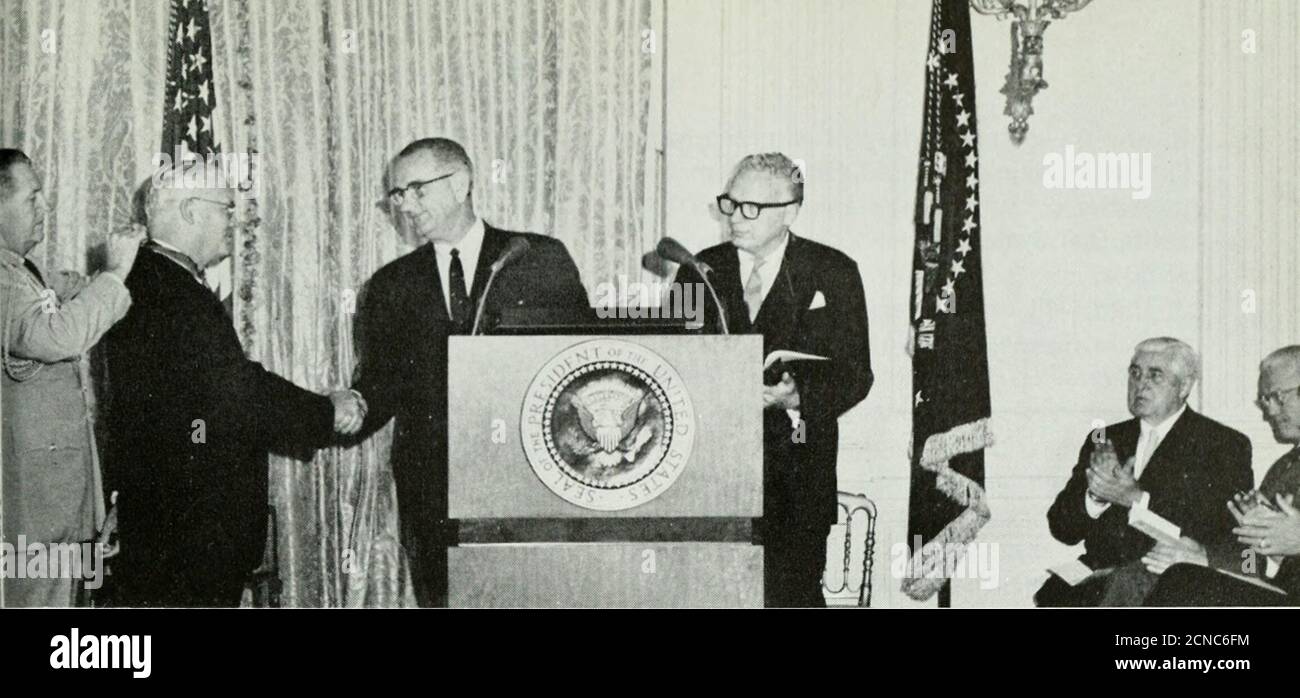 . Bell telephone magazine . President Lyndon B. Johnson congratulates A.T.&T. Board Chairman F. R. Kappel after pre-sentiiii, him with Medal of Freedoni award in ceremonies at the White House, September 14. service the next day. Also, about 500 tollcircuits were out of service of the 900 orig-inally affected. The damage to telephoneplant was estimated at $1.3 million. Restoring telephone service was particu-larly difficult because many power lines weredown. In Jacksonville, for example, 90 percent of the city was without electricity. InBrunswick, Georgia, 70 per cent of the cus-tomers lost pow Stock Photo