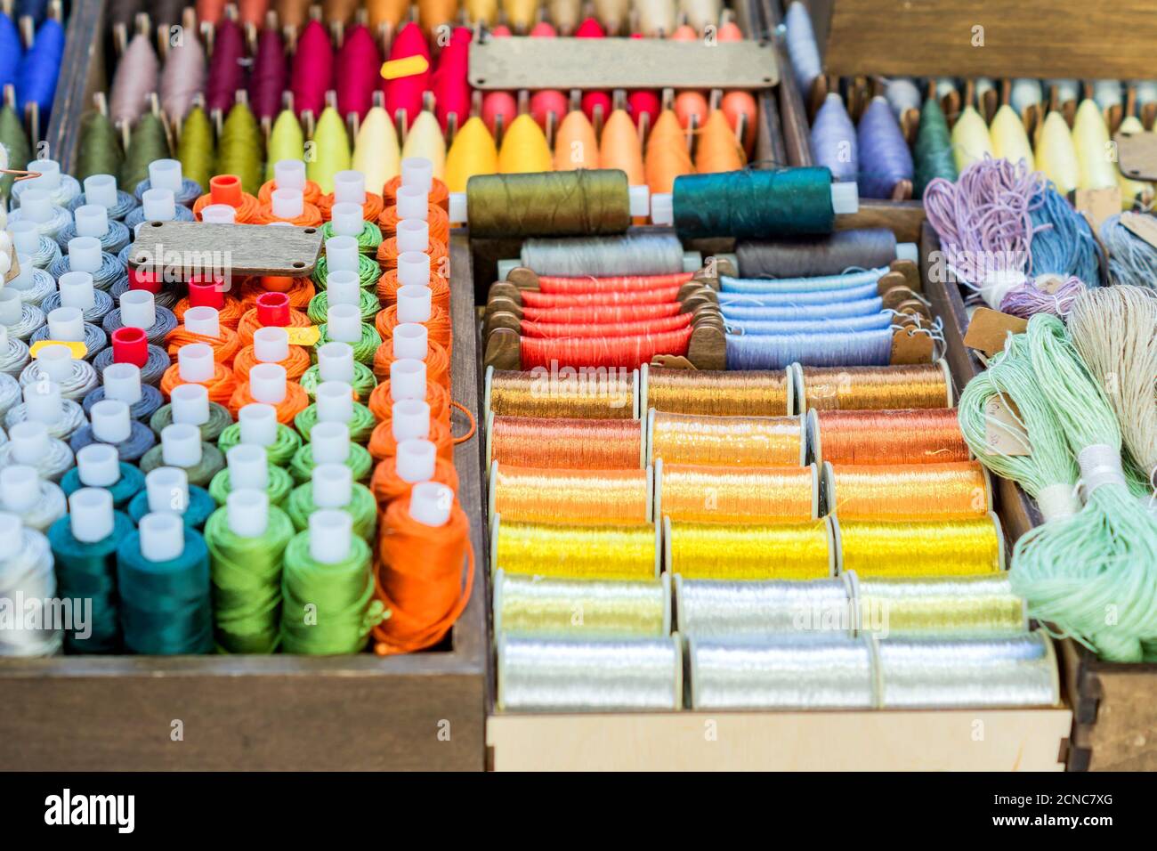 Assortment of multicolored thread spools for sewing Stock Photo