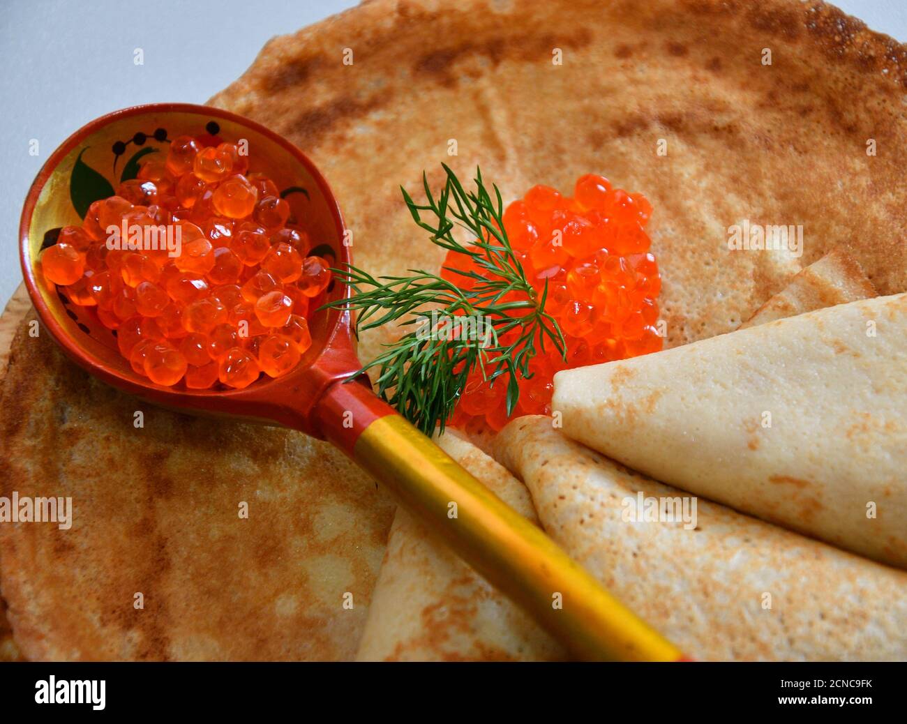 Pancakes with red caviar on the cutting board Stock Photo