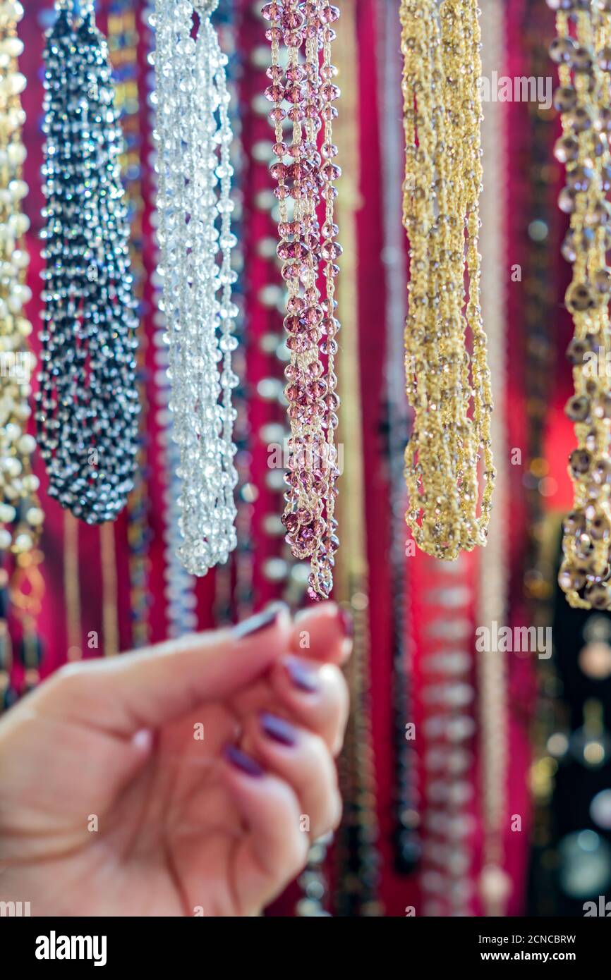 Woman choosing colorful crystal beads necklaces. Background pattern.  Handicraft fashionable for women Stock Photo - Alamy