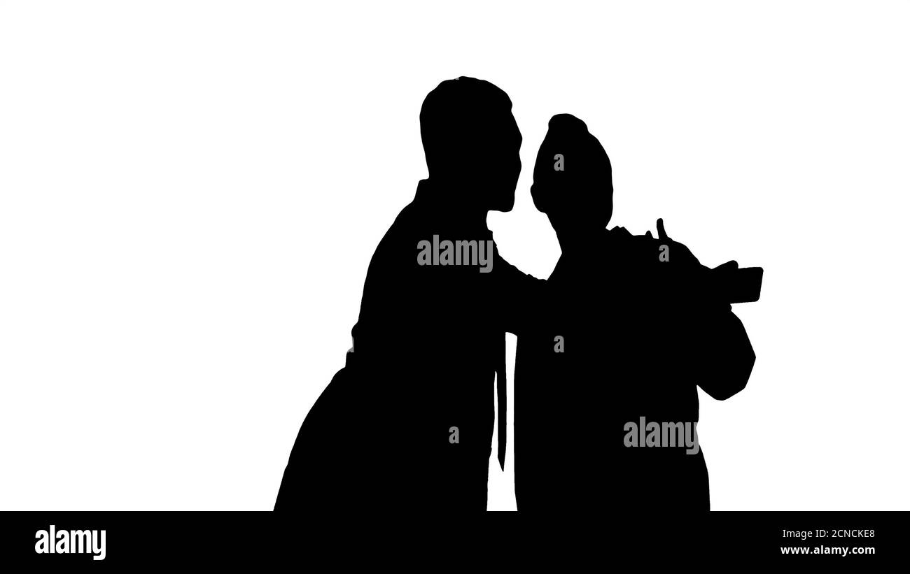 Silhouette Two doctors are making selfie using a smartphone and Stock Photo