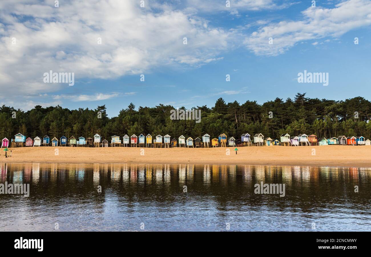 Beach huts at Wells-next-the-Sea reflected in the incoming tide. Stock Photo