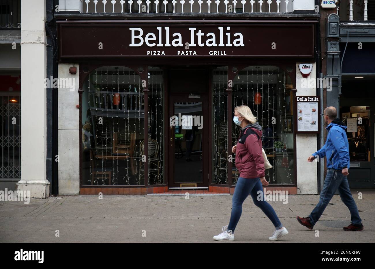 People walk by a Bella Italia restaurant in Chester, Britain, July 3, 2020. REUTERS/Molly Darlington Stock Photo