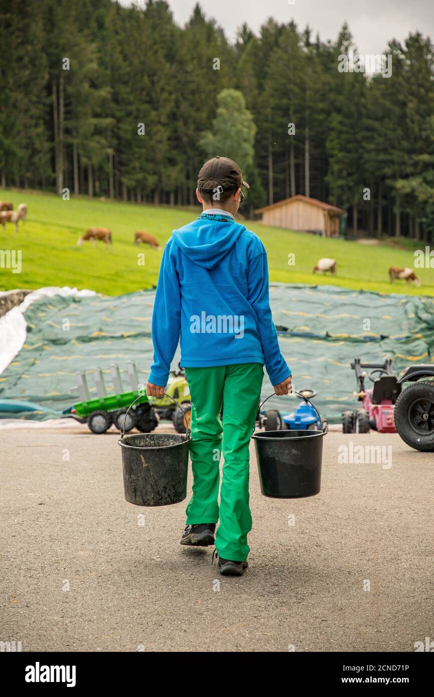 Children carrying water buckets on hires stock photography and images