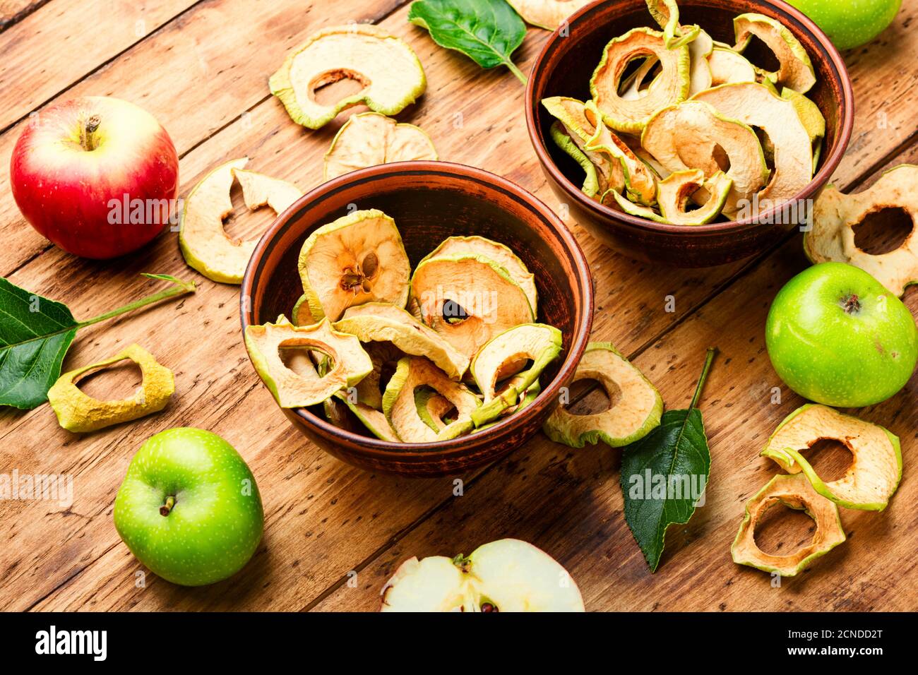 Apple chips on rustic wooden background.Dried apples Stock Photo