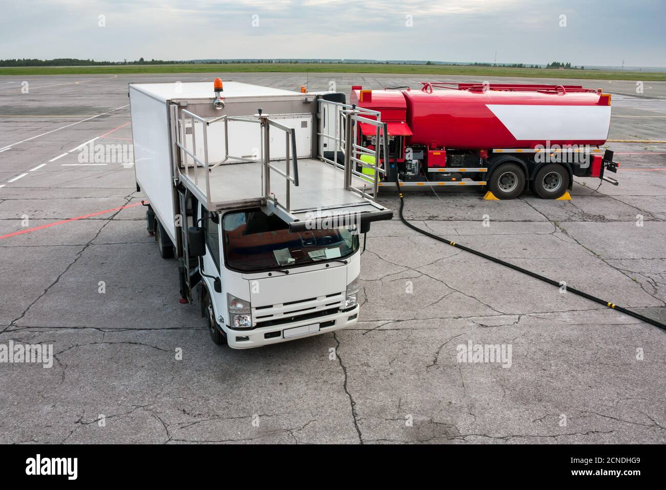 Airport catering truck and refueling truck on apron Stock Photo - Alamy
