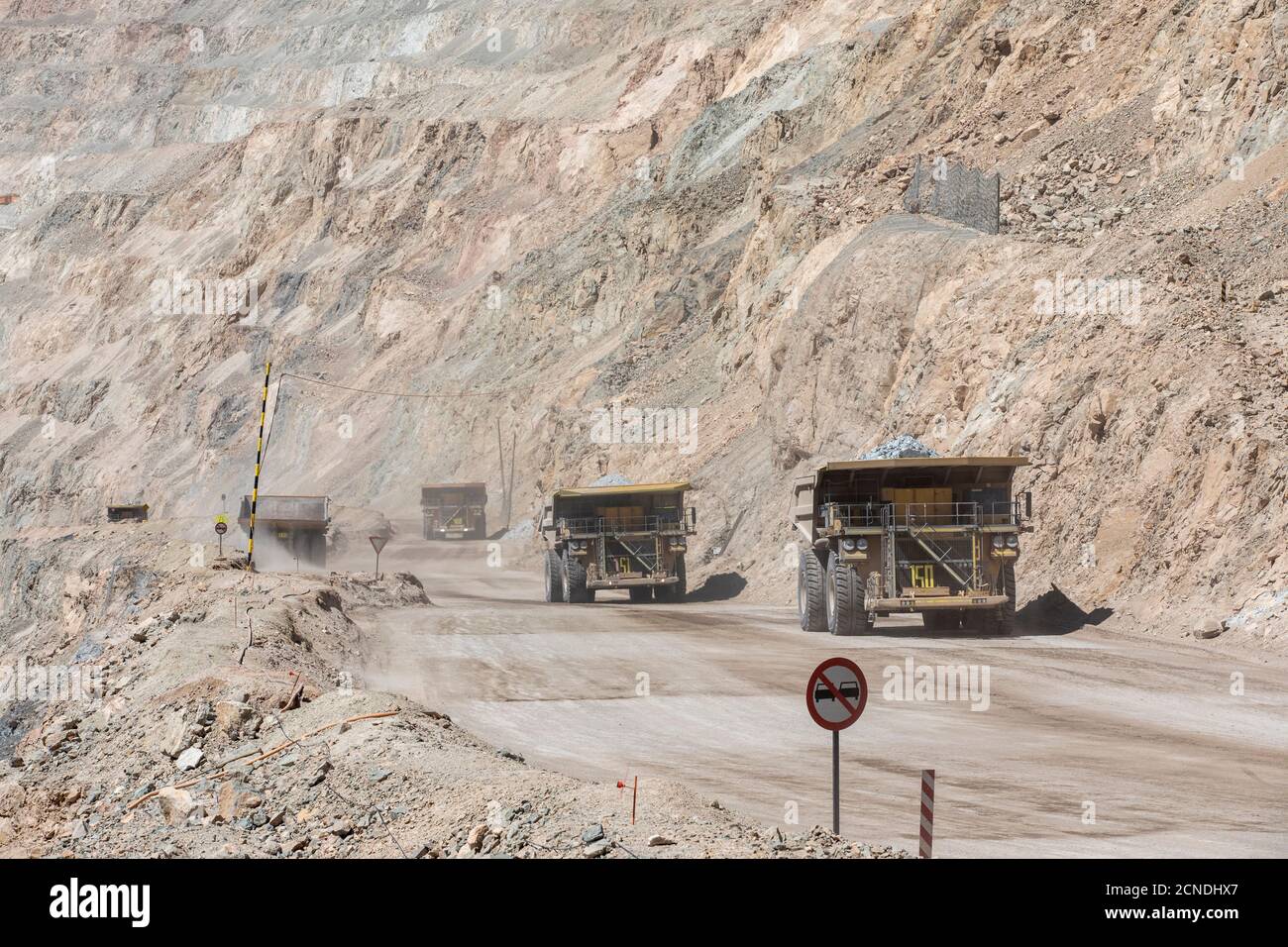 Huge dump trucks working the Chuquicamata open pit copper mine, the largest by volume in the world, Chile Stock Photo