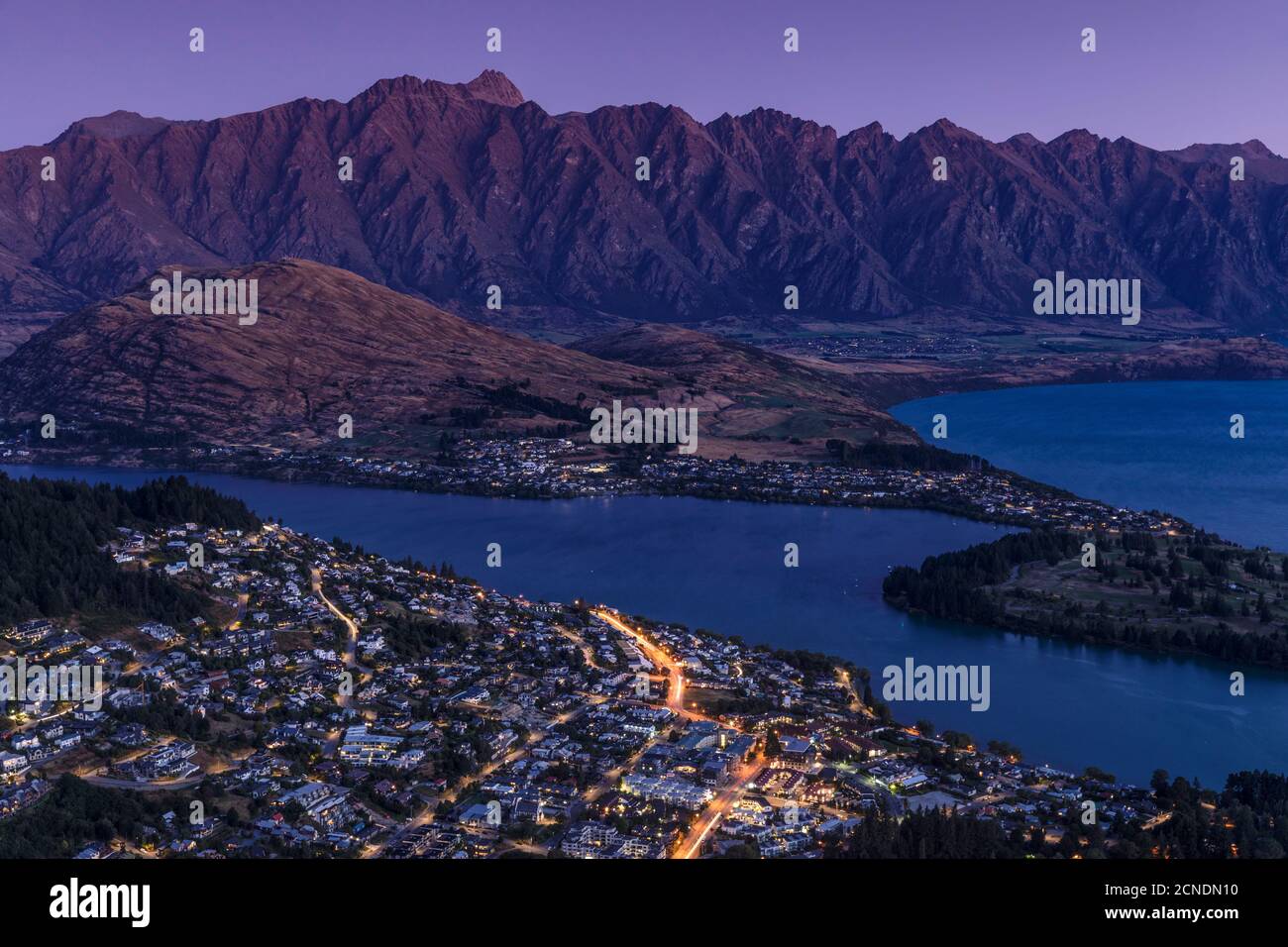 View over Queenstown and Lake Wakatipu to The Remarkables Mountains, Otago, South Island, New Zealand, Pacific Stock Photo