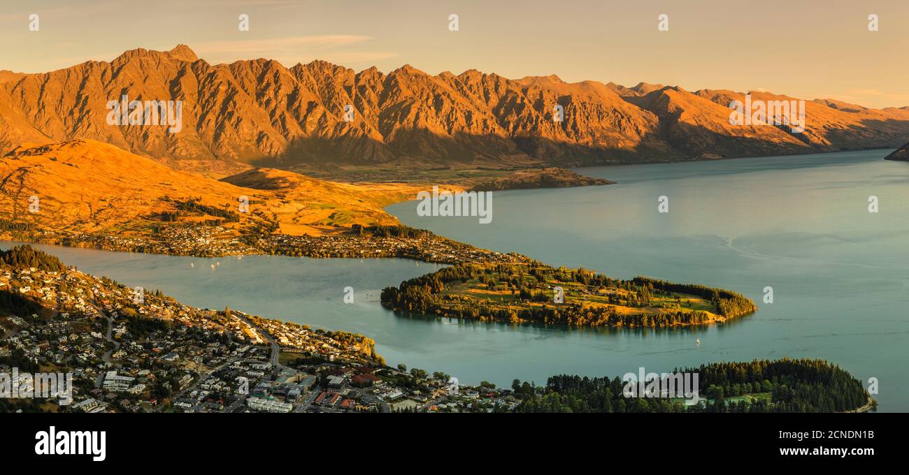 View over Queenstown and Lake Wakatipu to The Remarkables Mountains at sunset, Otago, South Island, New Zealand, Pacific Stock Photo