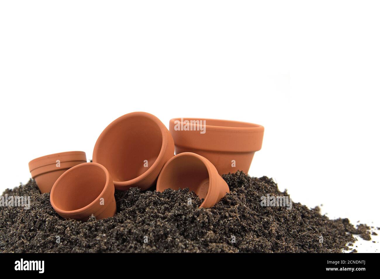 Empty flower pots and potting soil against white background Stock Photo