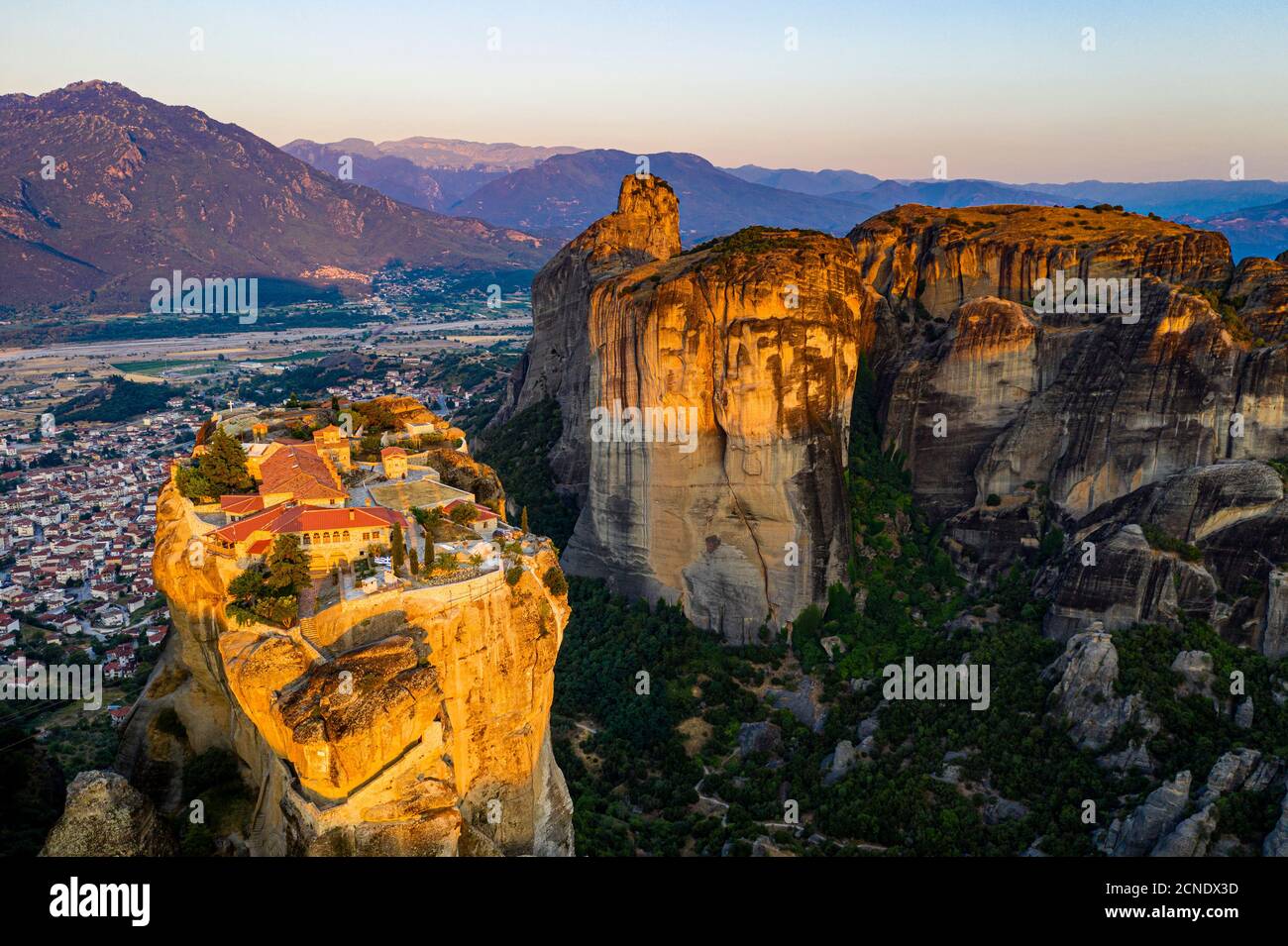 Aerial by drone of the Holy Monastery of Holy Trinity at sunrise, UNESCO World Heritage Site, Meteora Monasteries, Greece, Europe Stock Photo