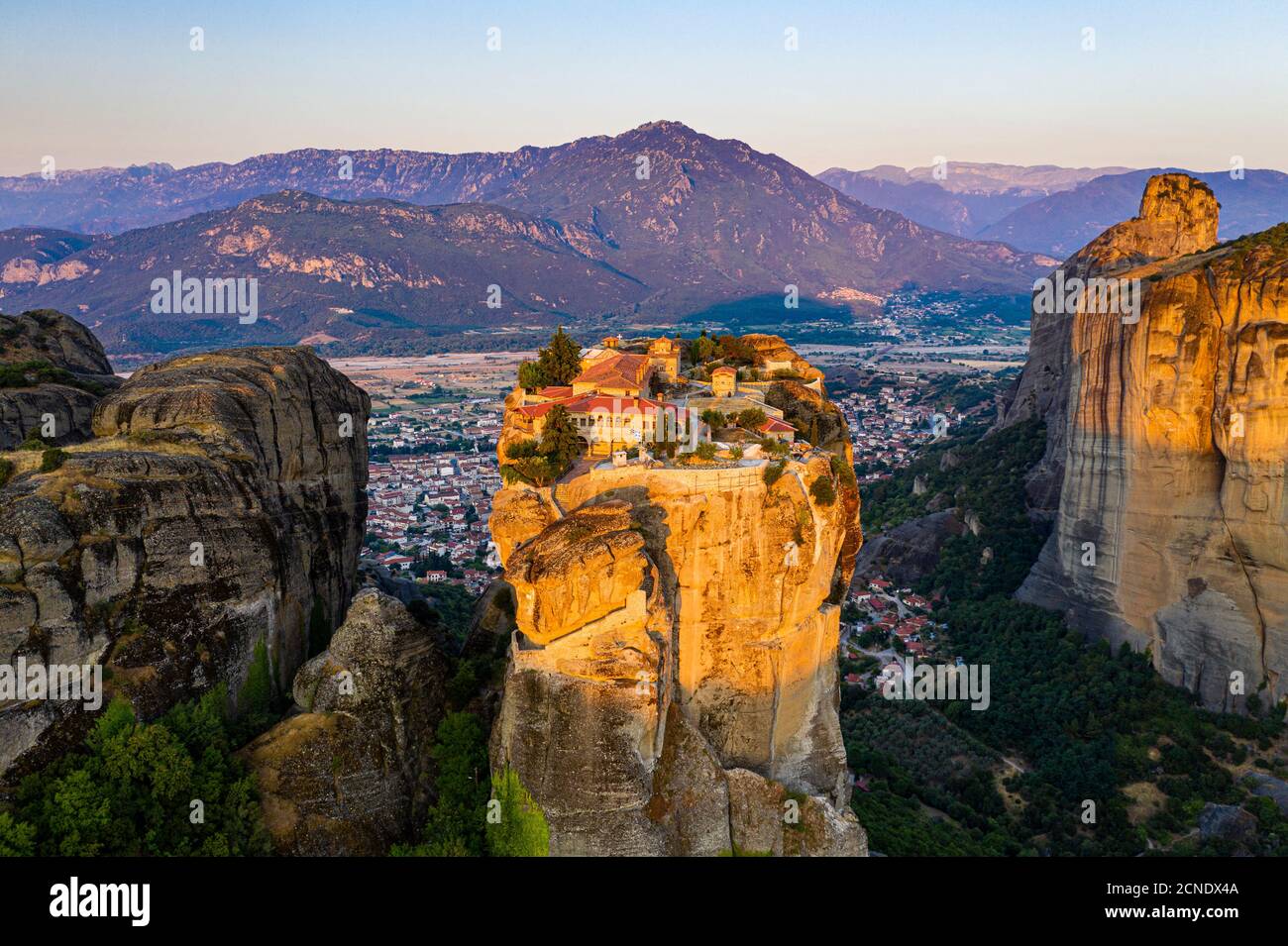 Aerial by drone of the Holy Monastery of Holy Trinity at sunrise, UNESCO World Heritage Site, Meteora Monasteries, Greece, Europe Stock Photo